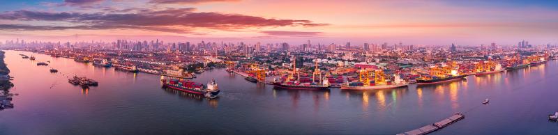 Panorama Two Waterways Many Ships Docks Cranes Distant City AdobeStock_268598603.jpeg 