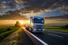 Truck at Dusk Countryside Two-lane, clouds and sun at the horizon AdobeStock_175552045.jpeg